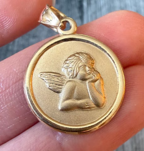 14K Gold Cherub or Angel Charm: Classical Renaissance-inspired solid 3D cherub baby angel figurine shown in deep contemplation with detailed folded wings and a frosted/polished contrasting texture. Height: 16 mm x 11 mm wide. Weight