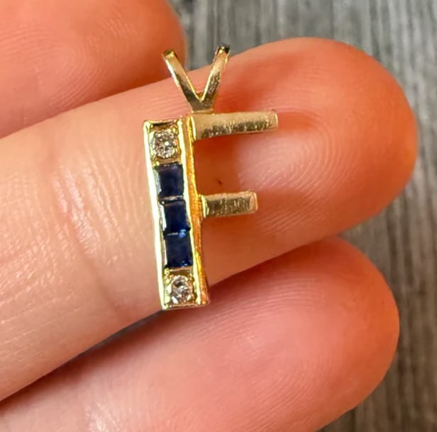 Sapphire and Diamond Initial F Charm: Small script initial alphabet letter "F" pendant charm set with 4 tiny square-cut natural navy sapphires and 3 single-cut white diamond accent points. Dimensions: 13 mm x 9 mm. Weight: 0.9 grams.