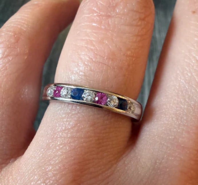 Ruby, Sapphire, and Diamond Band in 14K White Gold: Sleek modern stacking or wedding eternity band channel-set across the top half with alternating triplets of princess step-cut natural red rubies, dark blue sapphires, and square white diamonds. Band w