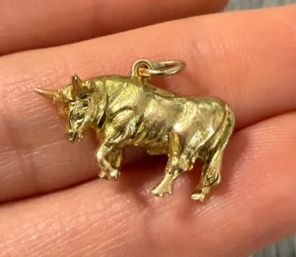 Solid Vintage 14K Gold Taurus or Bull Charm: Heavy, solid-cast three-dimensional charging bull figurine with realistic textured anatomical details and a polished finish. Measures 22 mm from horns to tail; height 14 mm. Weight: 7.3 grams.