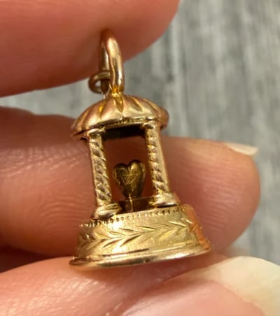 Vintage 14K Gold Heart Inside a Gazebo or Building Charm: Romantic multi-tier architectural pavilion or gazebo charm with open wire pillars housing a central red enamel swinging heart dangling inside. Hexagonal base measures 13 mm wide; total height 21 mm. W