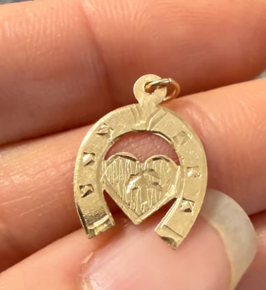 Vintage 14K Gold Heart and Horseshoe Charm: Good luck motif pendant combining a lucky upturned horseshoe seamlessly layered over a smooth, high-polished traditional heart. Dimensions: 15 mm x 13 mm. Weight: 1.1 grams.