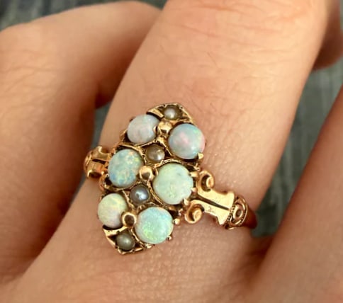 Victorian Opal and Pearl Navette Style Ring: Classic antique elongated navette-shaped marquise ring head featuring 3 vertically aligned natural fiery cabochon opals showing strong green/blue play-of-color, bordered by a frame of 14 small natural
