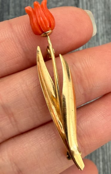 Carved Coral Tulip and 14K Gold Pin: Delicate organic pin featuring a hand-carved natural Mediterranean salmon-pink coral bud shaped like a closing tulip, mounted to a hand-wrought 14K gold stem with an etched leaf accent. Pin dimensions