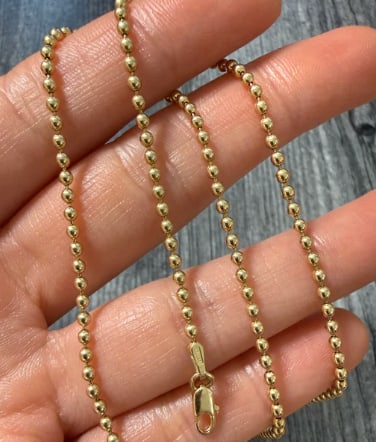 Uno A Erre 14K Gold Ball Chain, 18.25" Long: Italian designer piece by UnoAErre. High-quality military-style spherical ball chain meticulously crafted with seamless, high-shine gold beads. Secure barrel clasp closure. Ball diameter: 3.0 mm. Leng