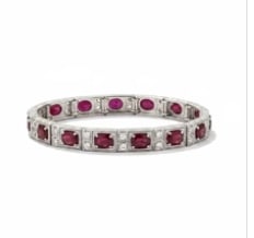 Platinum Engraved Ruby Bracelet: Masterfully crafted elite platinum line bracelet inset with vibrant, rich red square step-cut natural rubies, bordered on both profiles by intricate hand-carved floral scroll engravings. Length: 6.75