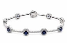 14k Sapphire Bracelet: Vibrant multi-gem line accessory. Features repeating pairs of rich navy blue square-cut natural sapphires alternated with bright white gold illusion-set diamond accents. Length: 7.0 inches. Weight: