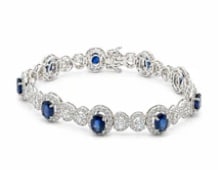 18k Sapphire Bracelet: Exceptional master-crafted 18K white gold flexible cuff line bracelet channel-set with an exquisite, uninterrupted row of premier caliber-cut cornflower blue sapphires (approx 12.0 ctw). Length: 6.85