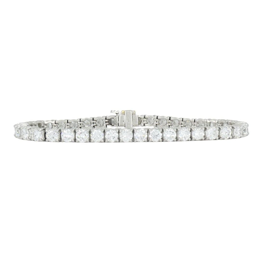 Vintage Cartier Platinum Diamond Tennis Bracelet, Circa 1970s: Spectacular vintage 1970s tennis line bracelet from Cartier. Hand-crafted in heavy premium platinum, seamlessly holding a continuous uniform row of exceptionally matched, ultra-brilliant round