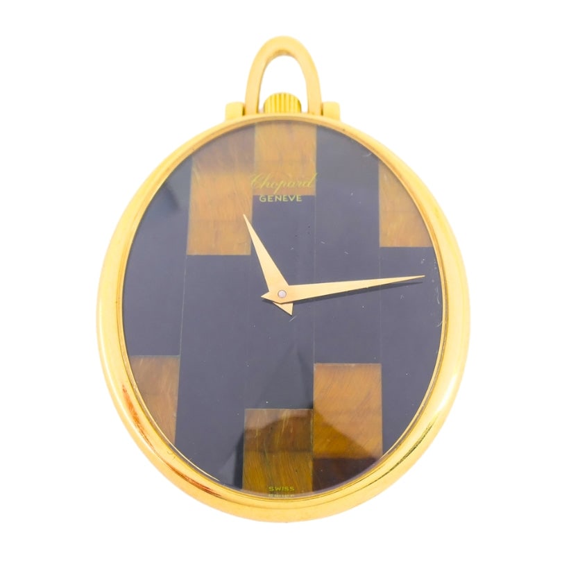 Vintage Chopard Watch 18k Gold Pendant Tiger’s Eye Black Onyx: Exceptional retro horological novelty signed Chopard. A functional mechanical miniature watch hidden inside a heavy 18K yellow gold sculpted medallion frame, beautifully inlaid with alternating