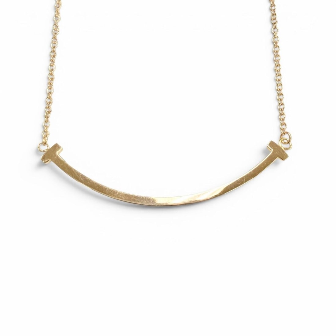 TIFFANY&Co. Tiffany T Smile Small Pendant Necklace, Pink Gold 18K, with Box and Case, Weight 2.67g,: --- Catalog ---Category: SizePendant Size: 4mm x 57mm / 0.15'' x 2.24''Neck Circumference: 40.5 cm / 15.94''Category: DesignColor: Pink goldGender: WomenMaterial: Pink gold (18K)Necklace Type: Necklac