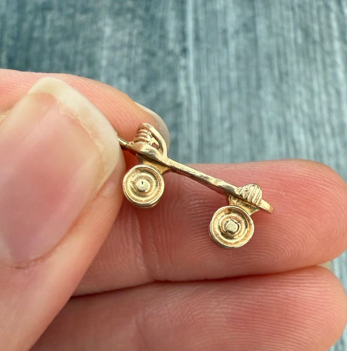 Vintage 14K Gold Spinning Roller Skate Charm: A playful vintage charm featuring a 14K gold roller skate with moving wheels.
