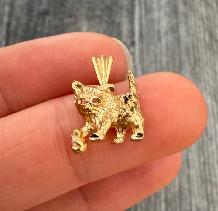 14K Gold Cat and Ball Charm: A playful charm featuring a cat sitting on a ball; classic midcentury design.