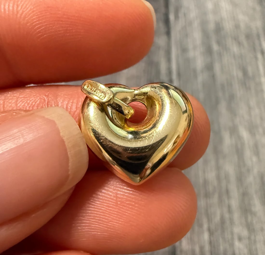 Puffy 14K Gold Heart Donut Charm: Metal: 14K Yellow Gold Weight: 2.6 gramsMeasurements: 0.55 inches long by 0.6 inches wideMarkings: "14KT ITALY"Condition: In very good condition with only minor surface wear.