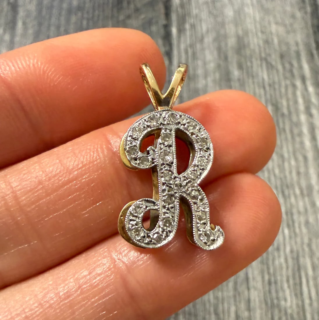 Diamond and 14K Gold Initial "R" Charm Diamond and 14K Gold Initial "R" Charm: Metal: 14K Yellow Gold Weight: 3.4 gramsDiamonds: Approximately 0.21 caratsMeasurements: 0.75 inches long by 0.55 inches wideCondition: In very good condition with some minor surface wear.