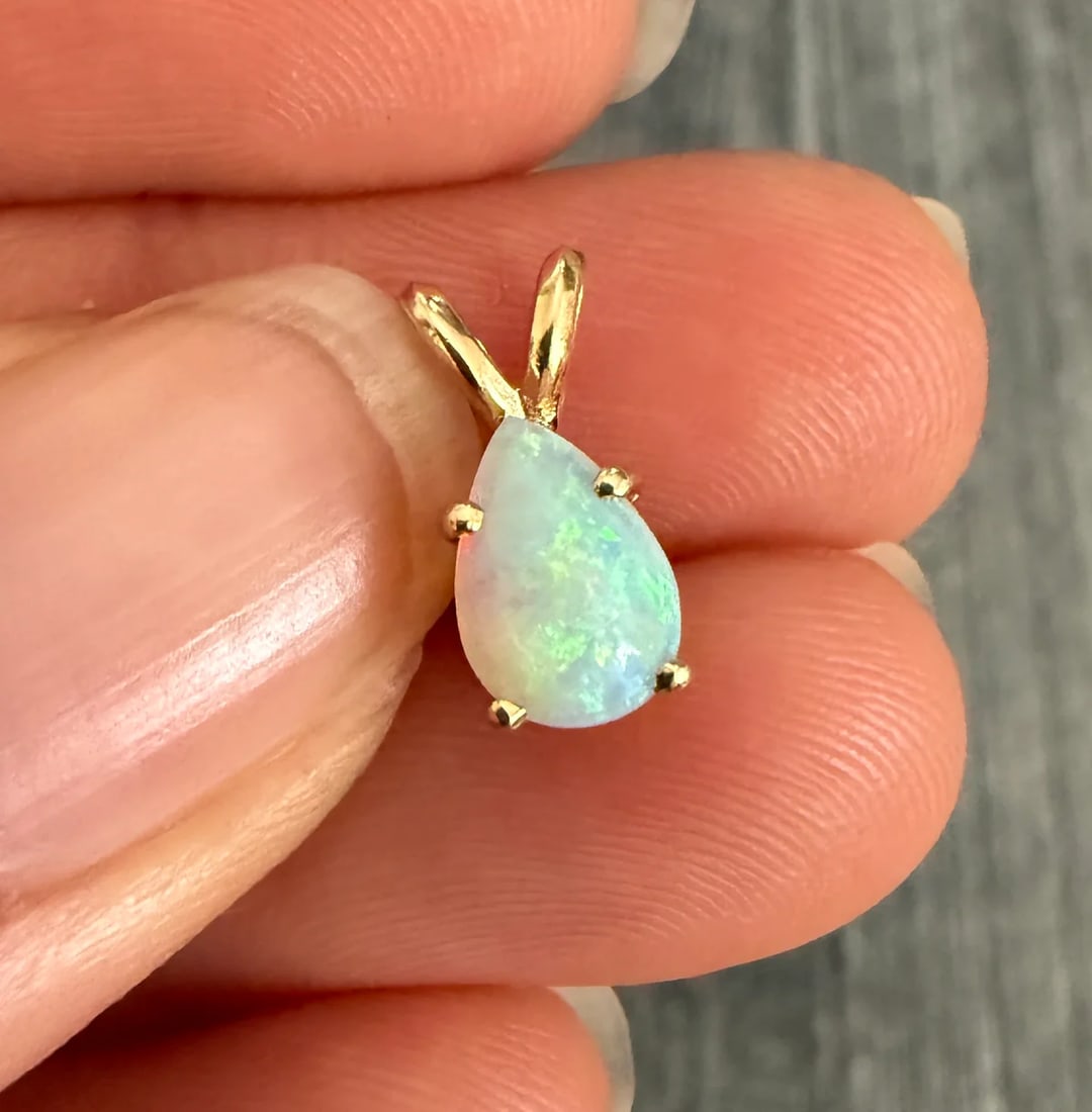 Teardrop Pear Shaped Opal Solitaire Charm: Metal: 14K Yellow Gold Weight: 0.8 gramsMeasurements: 0.35 inches long by 0.25 inches wideMarkings: "14KT"