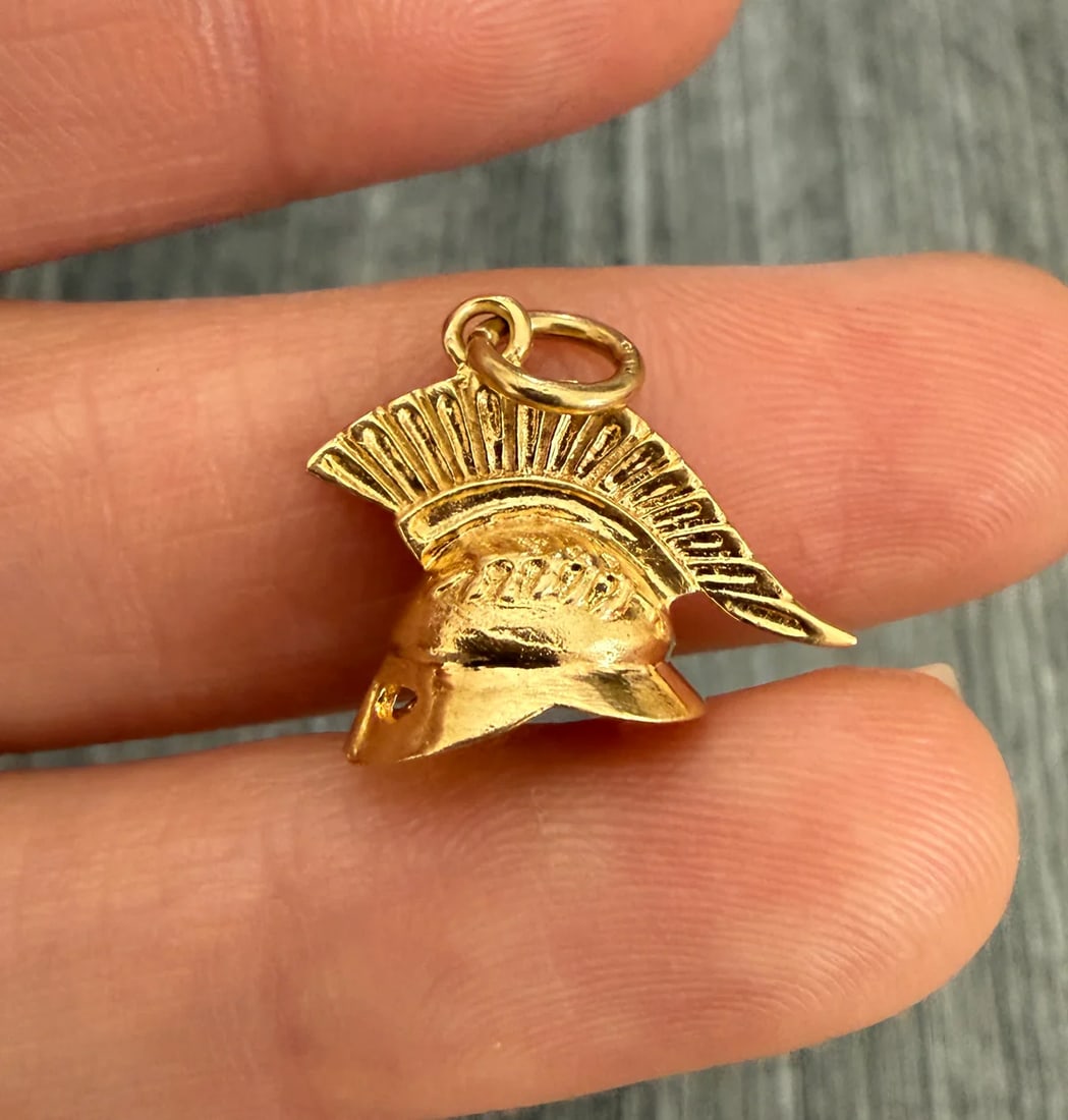 Vintage 14K Gold Warrior Helmet or Armor Charm: Metal: 14K Yellow Gold (acid tested)Weight: 2.5 gramsMeasurements: 0.5 inches long by 0.75 inches wide