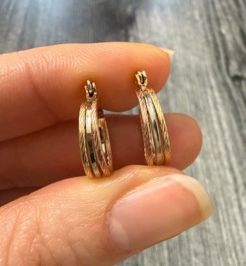 Tricolor 14K Gold Huggie Hoop Earrings: Stylish huggie hoops featuring twisted bands of yellow, white, and rose 14K gold.