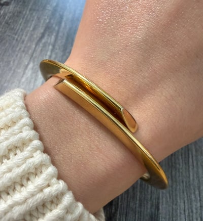 H.Stern 18K Gold Bypass Cuff Bracelet: A heavy designer 18K gold cuff with a modern bypass silhouette and straight-edge finishing.