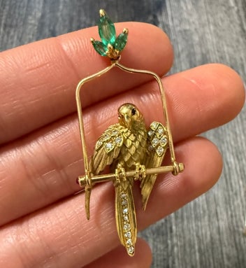 Diamond and Emerald Bird Pendant and Pin: An 18K gold tropical bird pendant/pin set with vibrant emeralds and diamond accents.