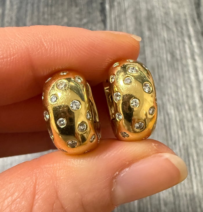 Diamond Etoile and 18K Gold Huggie Hoop Earrings: Luxurious 18K yellow gold huggie hoops featuring a "starry" etoile-style diamond setting with approximately 1.15 carats of diamonds.