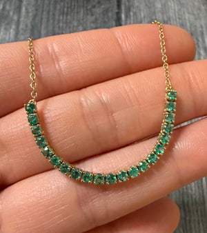 Emerald Tennis Style and Cable Link Chain Necklace: A 16-inch long 14K gold necklace combining a classic emerald tennis-style station with a sturdy cable link chain.