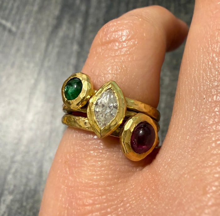 Stacked Diamond, Ruby, and Emerald 18K Gold Ring: A hand-hammered 18K gold ring featuring stacked rows of diamonds, rubies, and emeralds for a colorful, textured look.