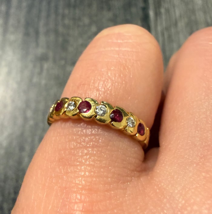 Alternating Ruby and Diamond Band in 18K Gold: A classic 18K gold stackable band featuring a row of alternating round-cut rubies and diamonds.