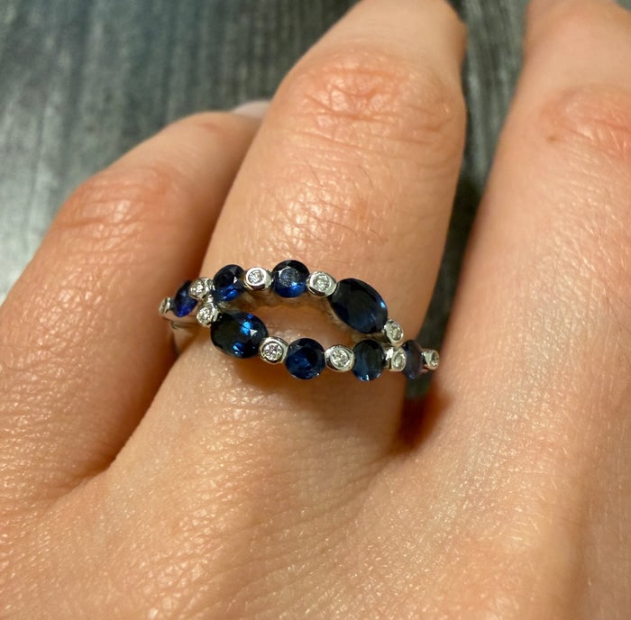 Sapphire and Diamond Bypass Marquise Ring: An 18K gold bypass-style ring featuring marquise-cut blue sapphires and diamond accents.