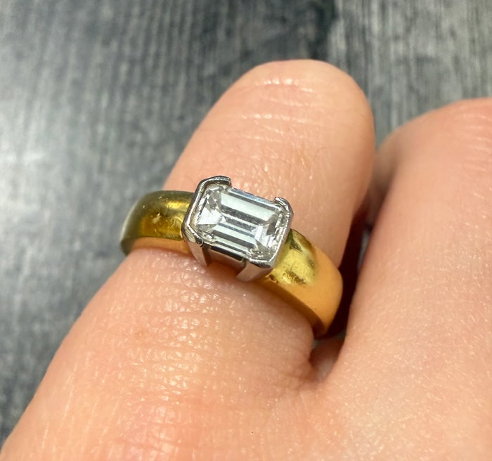Jeff Cooper Emerald Cut Diamond Band: A high-end designer band in platinum and 18K gold set with a row of brilliant emerald-cut diamonds.