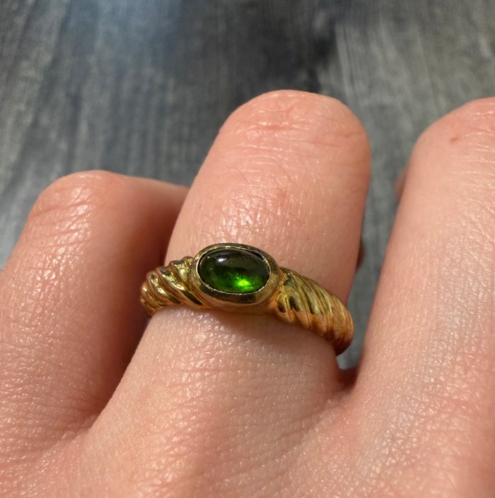 Cabochon Green Tourmaline Twist Band: A textured 14K gold twist-style band featuring a vibrant green cabochon tourmaline.