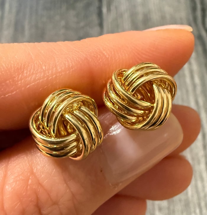Love Knot Stud Earrings in 14K Gold: Classic 14K yellow gold stud earrings featuring a polished, interwoven love knot design.