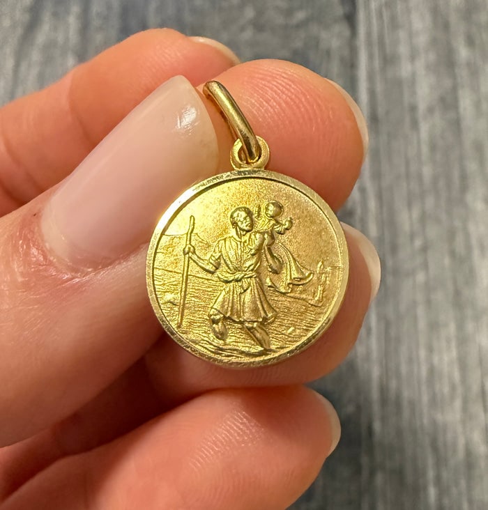 St. Christopher Charm in 14K Gold (Patron Saint): A classic 14K gold circular medal of St. Christopher, the patron saint of travelers.