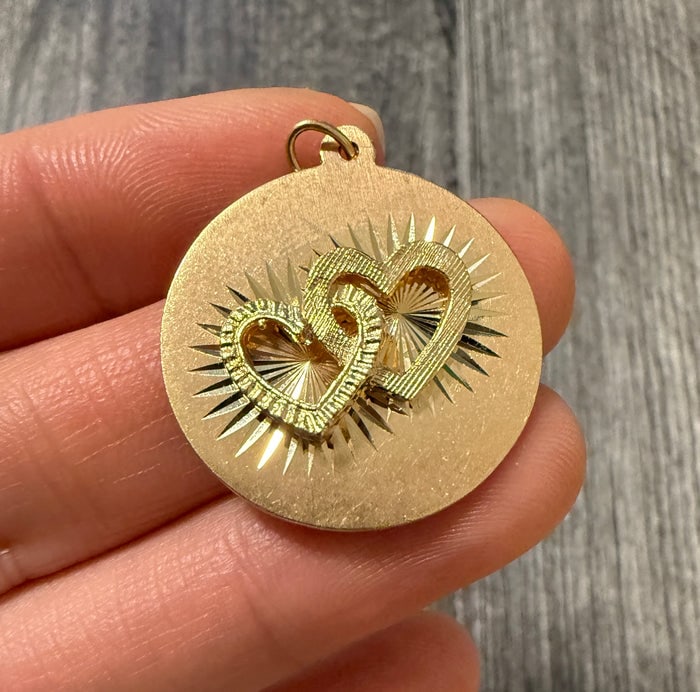 Vintage 14K Gold Charm of Interlocked Hearts: A sweet 14K yellow gold charm featuring two polished hearts permanently interlocked.