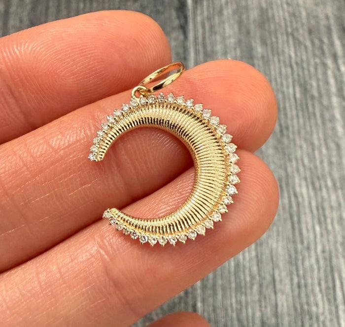 Diamond and 14K Gold Ribbed Crescent Charm: 14K gold crescent charm with ribbed texture and diamonds.