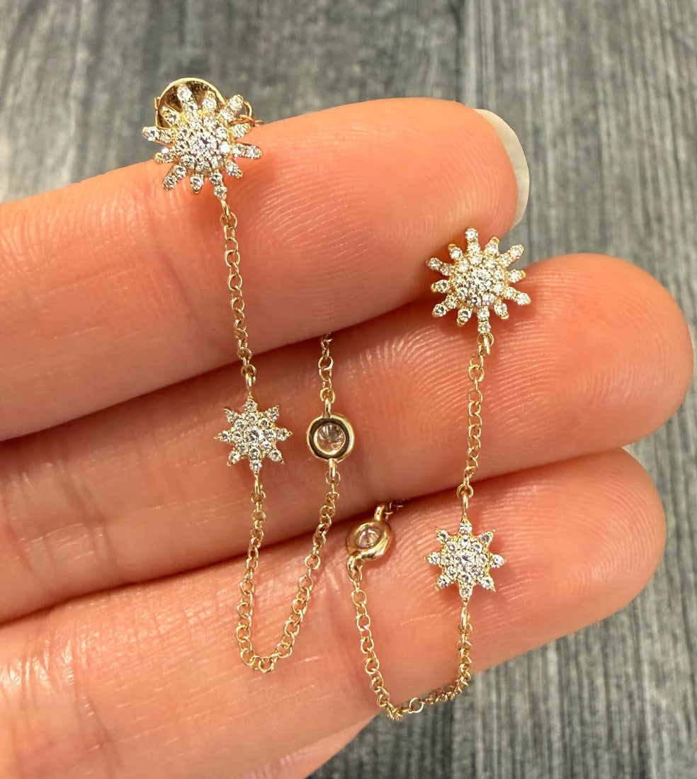 Diamond Starburst and Dangling Chain Earrings in 14K Gold: 14K gold earrings with a starburst design and dangling chains.