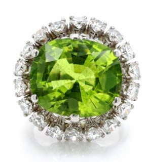 1960’s Platinum Peridot & Diamond Ring: A vintage mid-century ring in platinum featuring a bright green peridot center stone accented by period-style diamonds.
