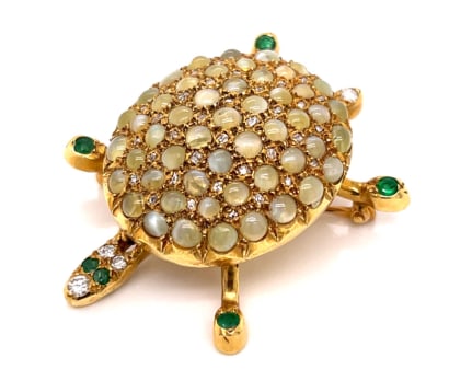 1960’s 18K Yellow Gold Diamond, Emerald, and Cat’s Eye Turtle Brooch: 18K Yellow Gold; 1960's Turtle design with Diamond, Emerald, and Cat's Eye.