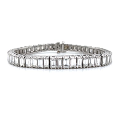 Art Deco Platinum Graduated 15.00 Ct. Emerald-cut Diamond Tennis Bracelet: Platinum; Art Deco style with 15.00 Ct. of Graduated Emerald-cut Diamonds.