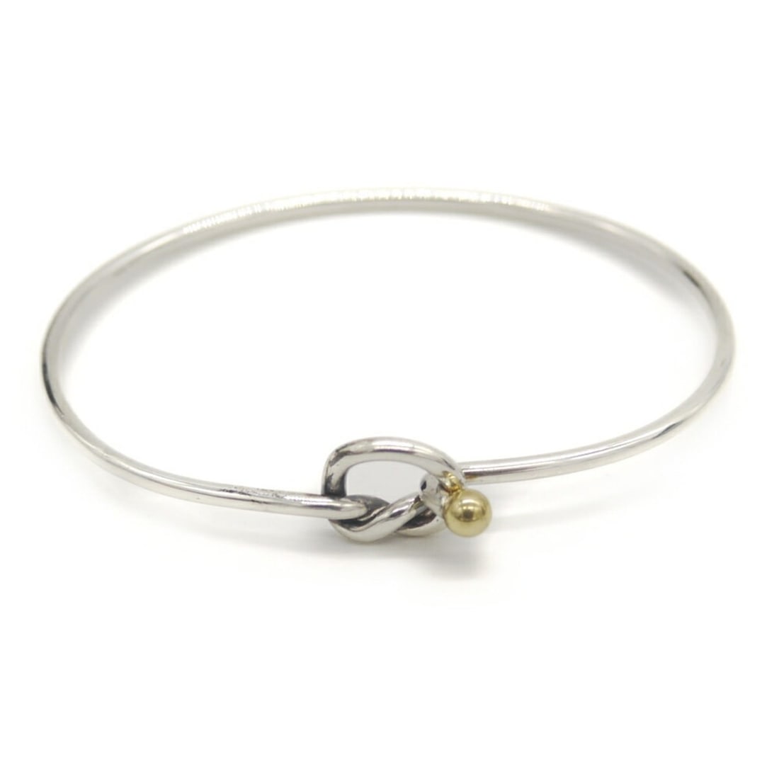 TIFFANY & Co. Tiffany Love Knot Bracelet, Sterling Silver 925 and 18K Gold: --- Catalog ---Category: SizeLength: 17cm / 6.69''Category: DesignType: BangleColor: Gold, SilverGender: WomenMaterial: Gold (18K), Silver 925Category: GeneralBrand: Tiffany--- Item List ---Section: