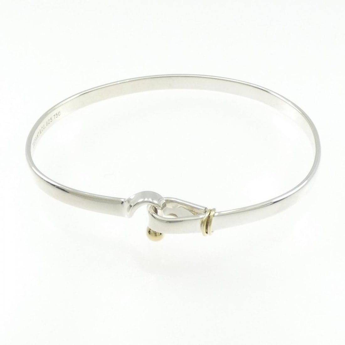 Tiffany Hook & Eye Bracelet: --- Catalog ---Category: SizeLength: 18cm / 7.08''Category: DesignType: BangleGender: WomenMaterial: Silver 925, Yellow gold (18K)Category: GeneralBrand: Tiffany--- Item List ---Section:
