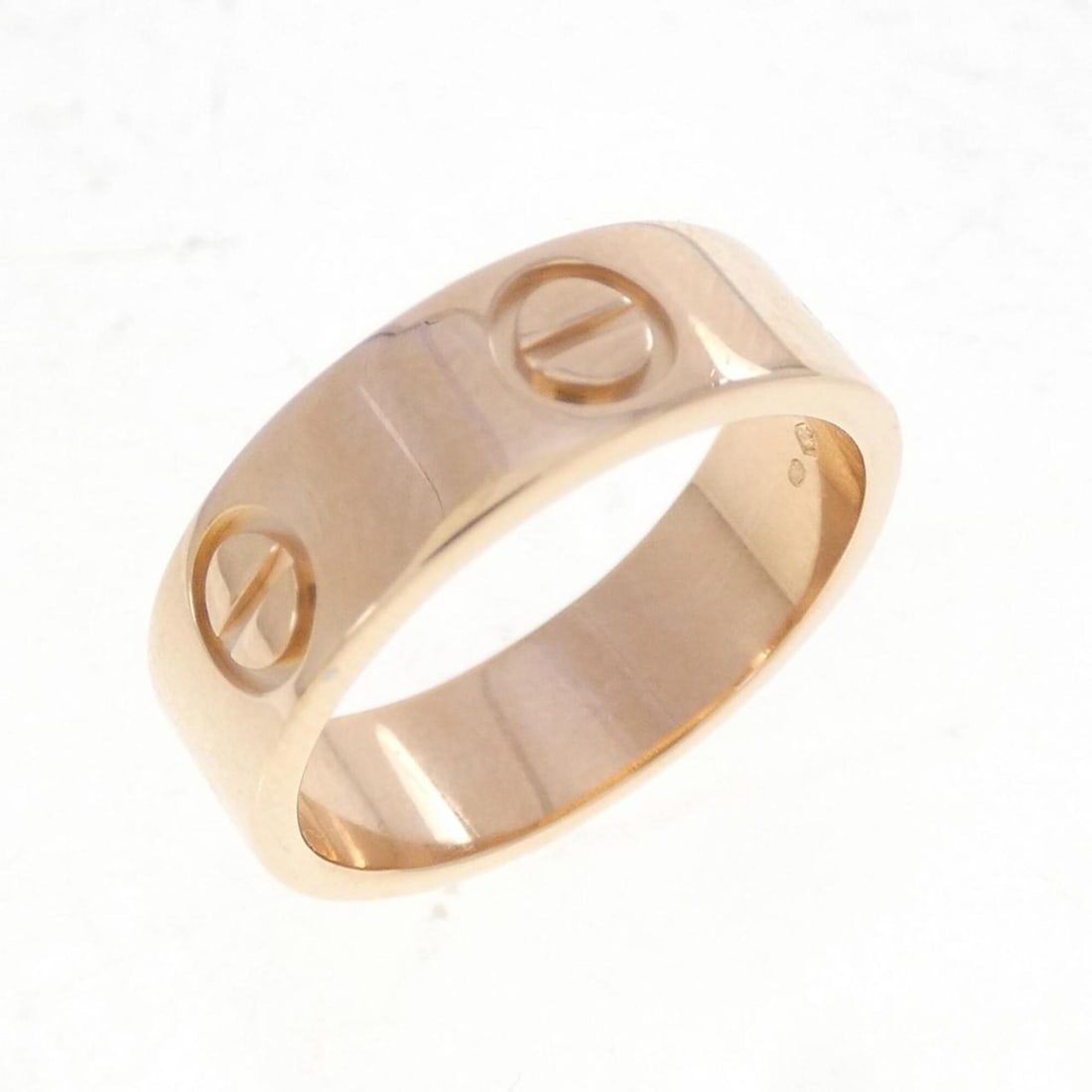 Cartier Love Ring: --- Catalog ---Category: SizeUS Size: 5.5Brand Size: 50Category: DesignType: Band ringGender: WomenMaterial: Pink gold (18K)Category: GeneralBrand: Cartier--- Item List ---Section: ConditionRanking:
