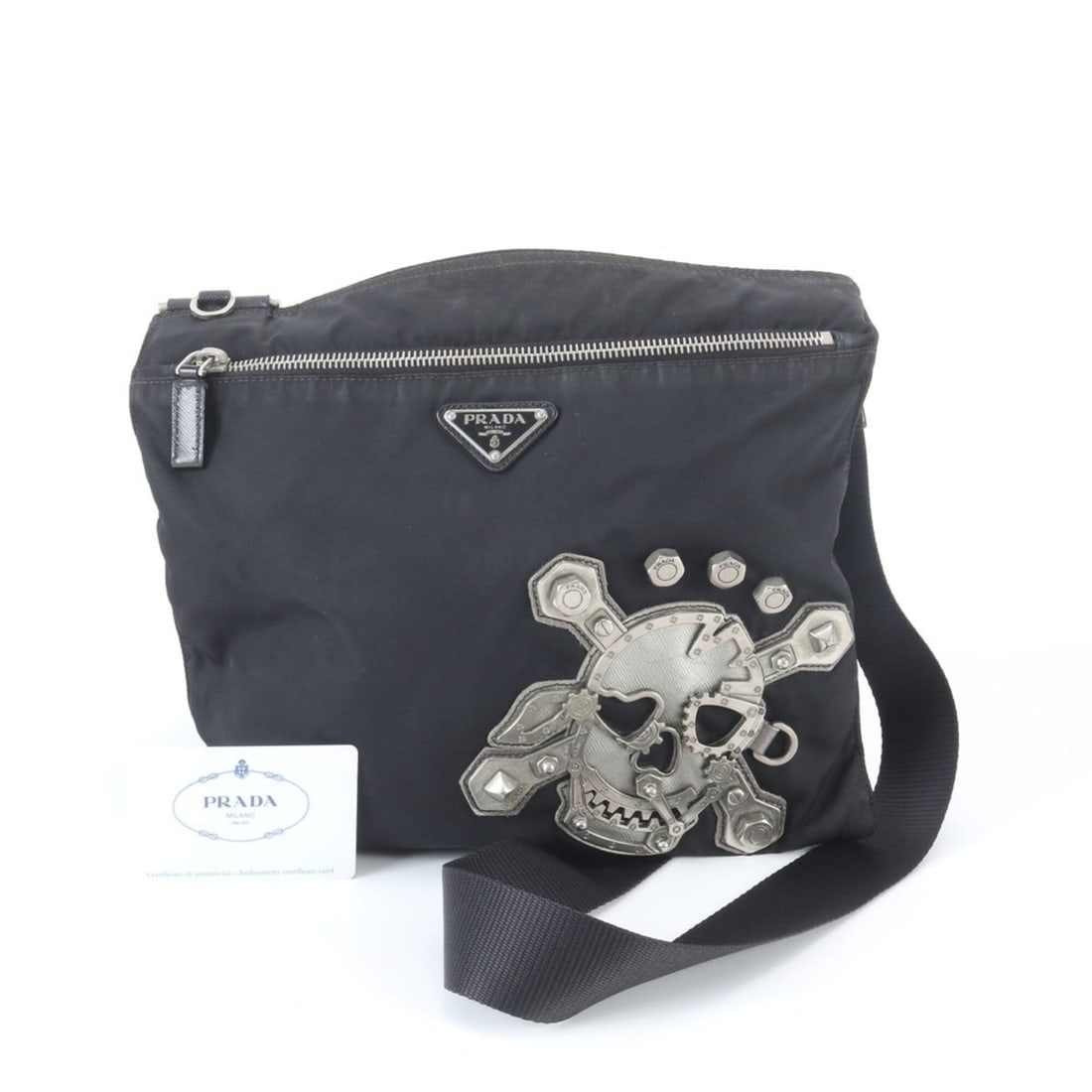 Prada Tessuto Nylon Skull Triangle Logo Shoulder Bag (VA0859) with Guarantee Card - Men's Crossbody: --- Catalog ---Category: SizeStrap Drop: 26cm / 10.23''Size (HxWxD): 25cm x 28cm x 1cm / 9.84'' x 11.02'' x 0.39''Strap Length: 126cm / 49.6''Category: DesignType: Shoulder bagColor: BlackGender: MenM