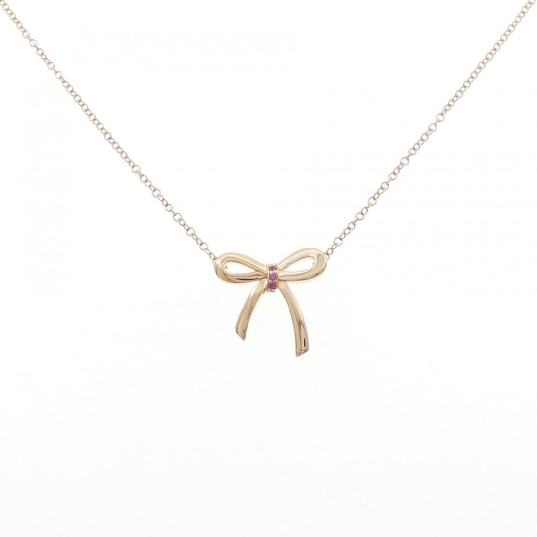 Tiffany & Co. 2017 Christmas Limited Edition Bow Necklace: --- Catalog ---Category: SizePendant Size: 13.9mm x 14.6mm / 0.54'' x 0.57''Neck Circumference: 41 cm / 16.14''Category: DesignColor: Pink goldStone: SapphireGender: WomenMaterial: Pink gold