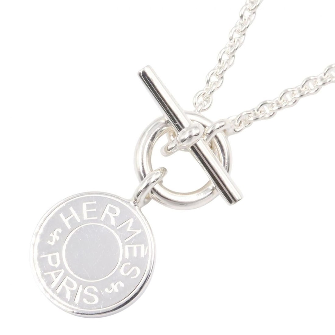Hermes Amulette Sellier Necklace, Sterling Silver 925, Women's Tone: --- Catalog ---Category: SizePendant Size: 14mm x 14mm / 0.55'' x 0.55''Neck Circumference: 40 cm / 15.74''Category: DesignColor: SilverGender: WomenMaterial: Silver 925Necklace Type: NecklaceCategory