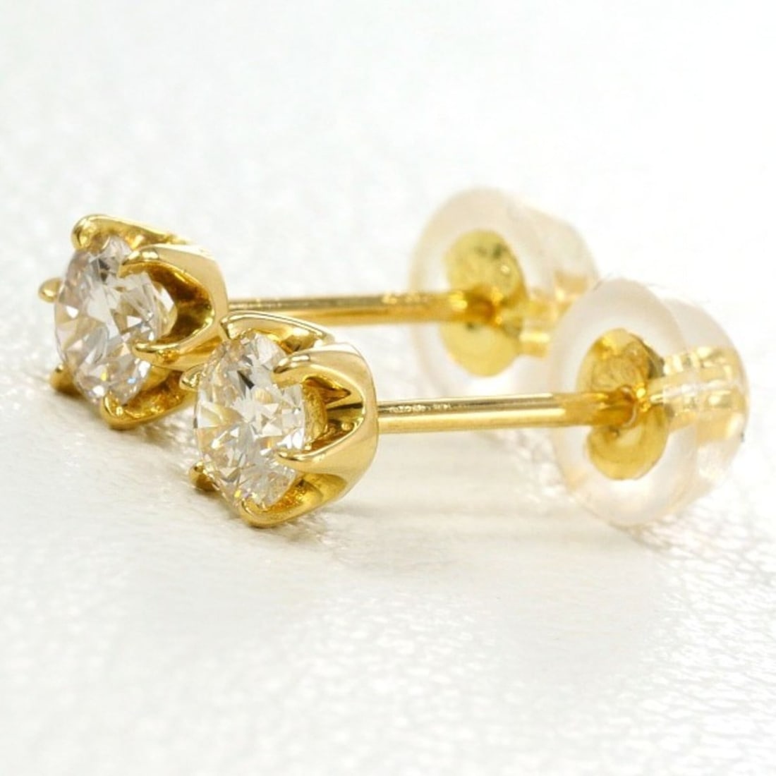 18K (18-karat) yellow gold earrings with two 0.15-carat diamonds. Total weight approximately 0.5g.: --- Catalog ---Category: SizeWeight: 0.5g / 0.01oz.Category: DesignType: Stud earringsColor: Yellow goldMetal: GoldStone: DiamondGender: WomenMaterial: Yellow gold (18K)Metal Purity: 18KWeight (ct.):