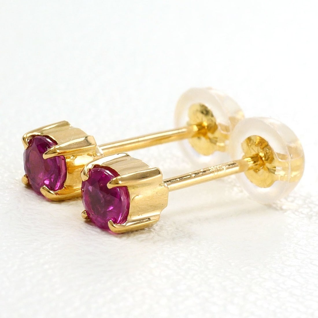 18K (18-karat) Yellow Gold Earrings with Ruby, Total Weight 0.7g, Jewelry: --- Catalog ---Category: SizeWeight: 0.7g / 0.02oz.Category: DesignType: Stud earringsColor: Yellow goldMetal: GoldStone: RubyGender: WomenMaterial: Yellow gold (18K)Metal Purity: 18KCategory: General