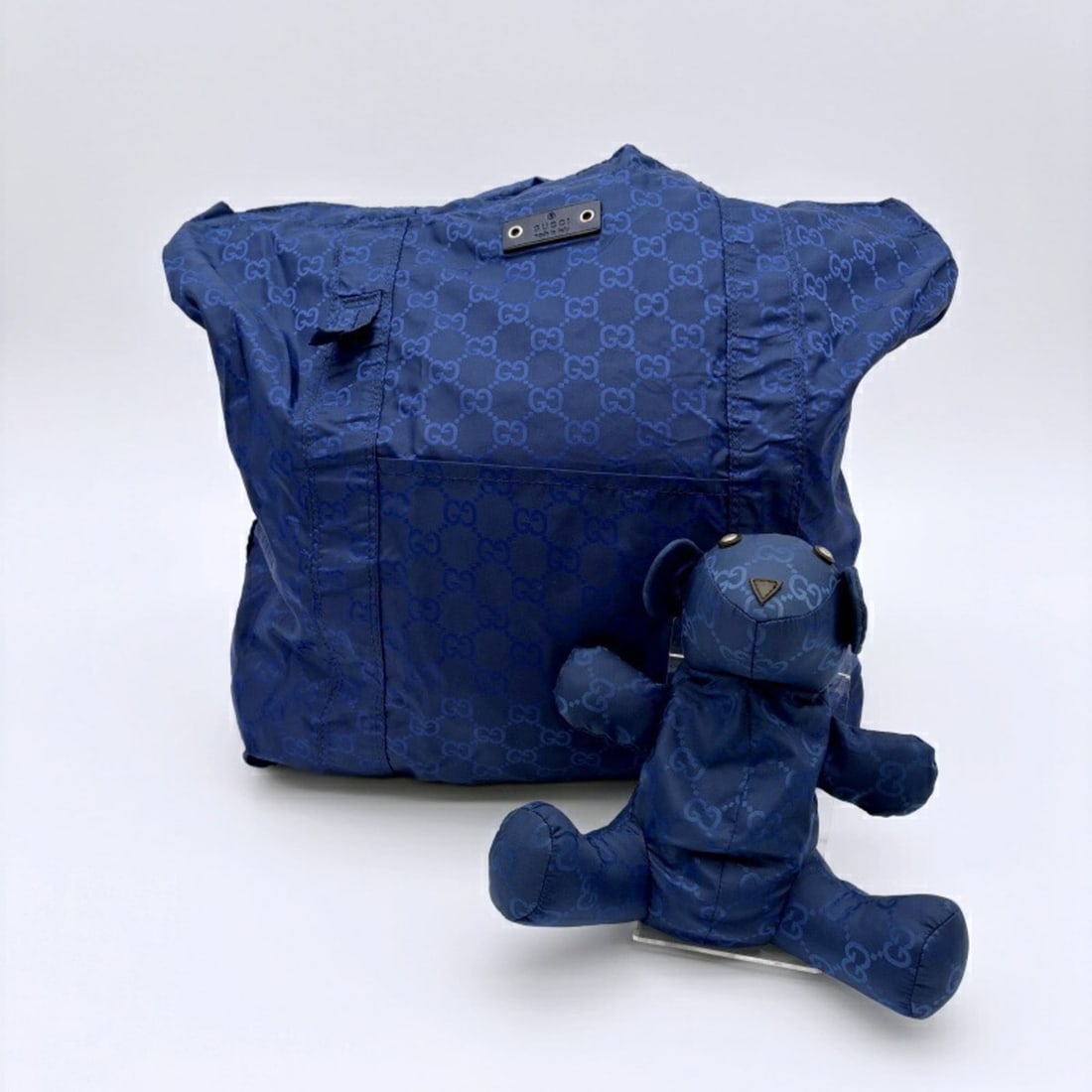 Gucci Teddy Bear Packable Tote Bag 223669 GG Nylon Navy Women's Eco Motif GUCCI: --- Catalog ---Category: SizeSize (HxWxD): 38cm x 34cm x 11cm / 14.96'' x 13.38'' x 4.33''Handle Length: 57.5cm / 22.63''Category: DesignType: Eco-bag, Tote bagColor: NavyGender: WomenClosure: OpenMat