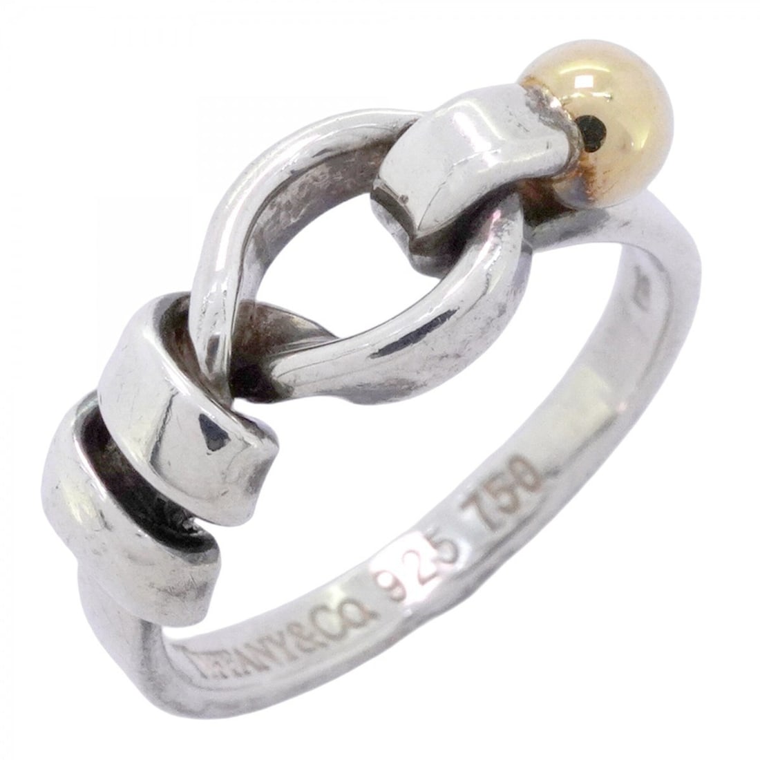 Tiffany & Co. Hook Eye Ring, 18K Yellow Gold (KYG), Sterling Silver 925, Size 9 (Women's): --- Catalog ---Category: SizeJP Size: 9US Size: 5Category: DesignType: Band ringGender: WomenMaterial: Silver 925, Yellow gold (18K)Category: GeneralBrand: Tiffany--- Item List ---Section: ConditionRa