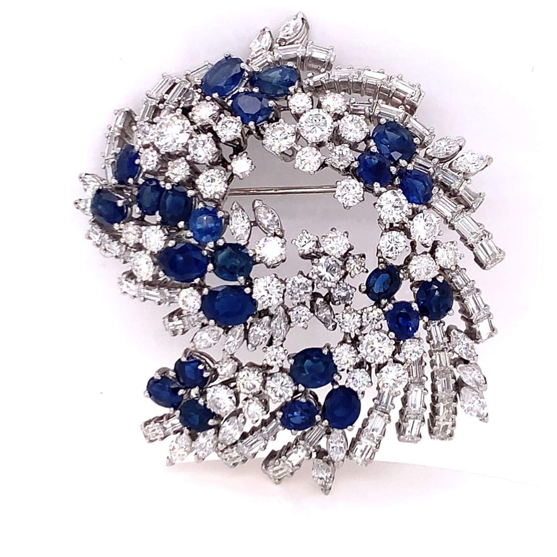 Art Deco Diamond and Sapphire Pin: Art Deco Diamond and Sapphire PinMounted with 23 Sapphires Weighing 12.00 Ct.* and 18.00 Ct.* of Diamonds F-G Color VVS-VS ClarityPlatinum Metal Weight: 50.80 gm.*approx. weight